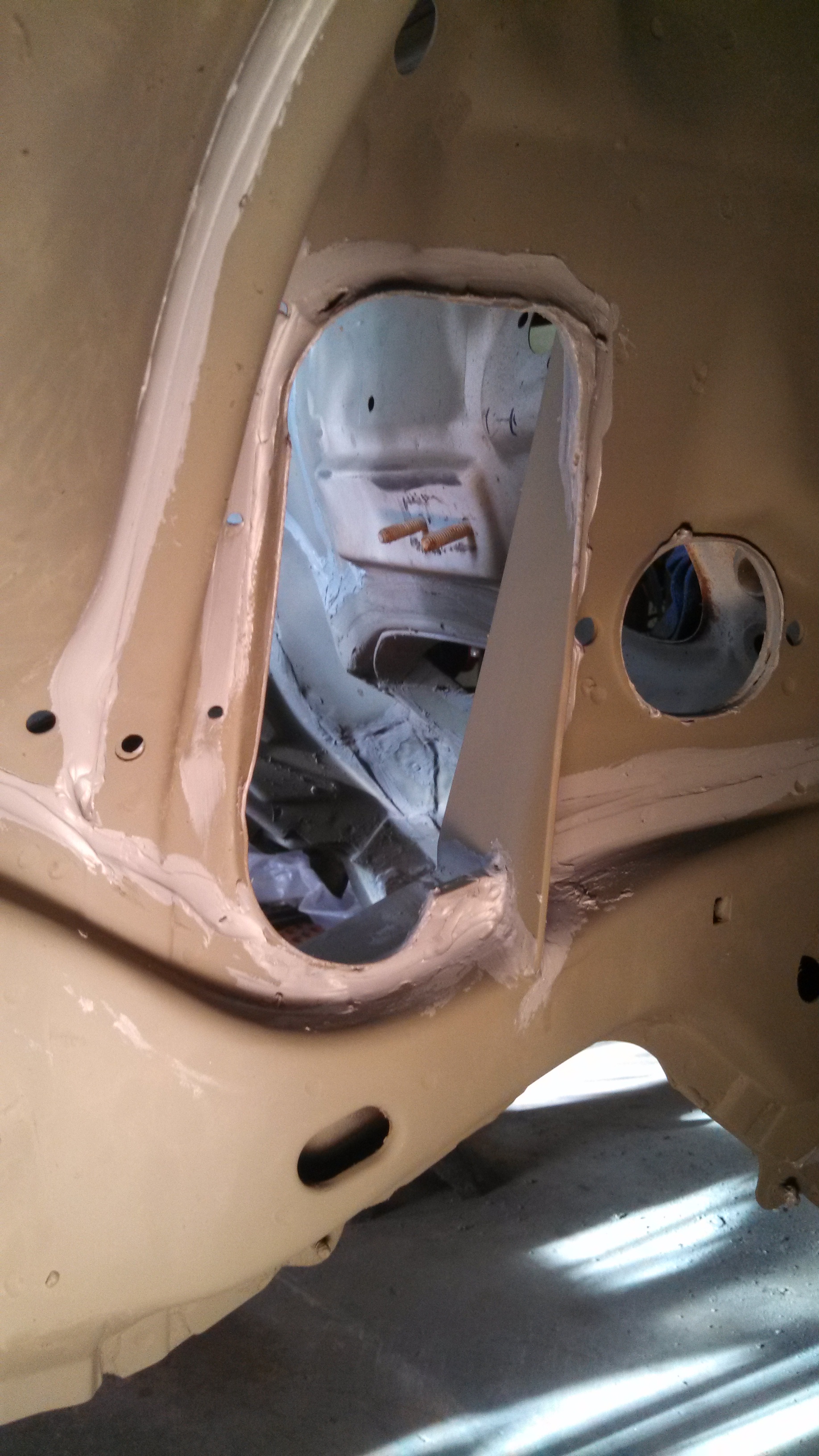 steering arm holes and brace welded and sealed.jpg